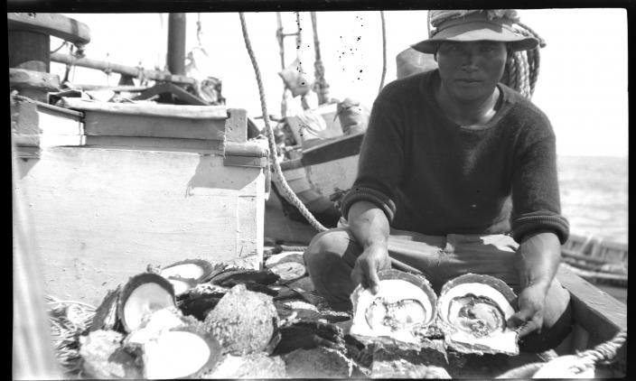 Image of a man sitting on a boat with pearlshekk